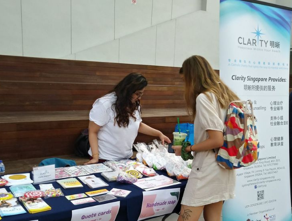 Mental health outreach event with volunteers at information table